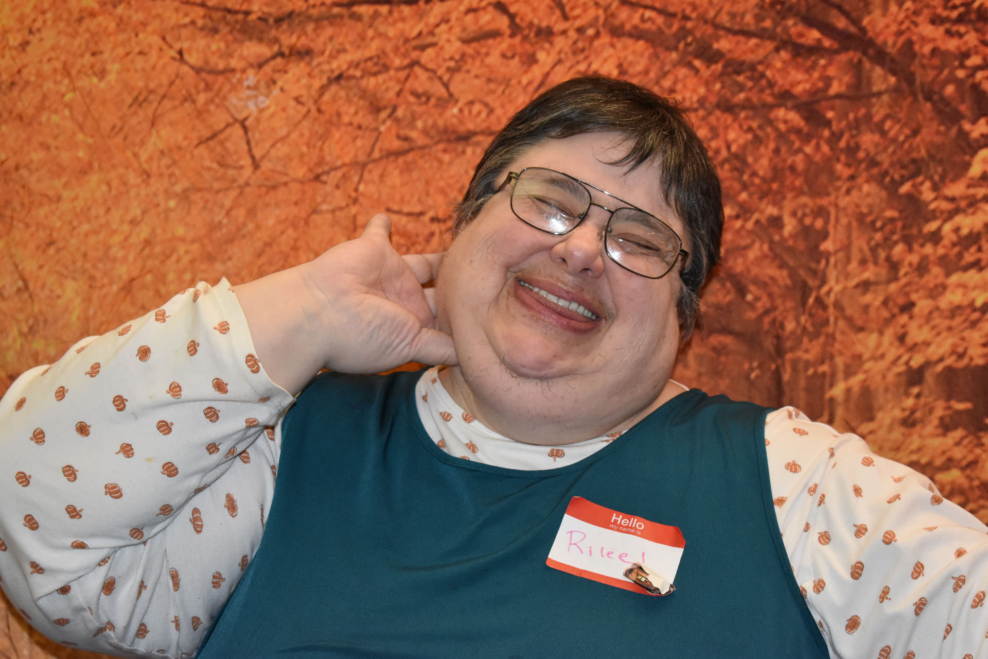 Rilee smiling brightly at a fall community event